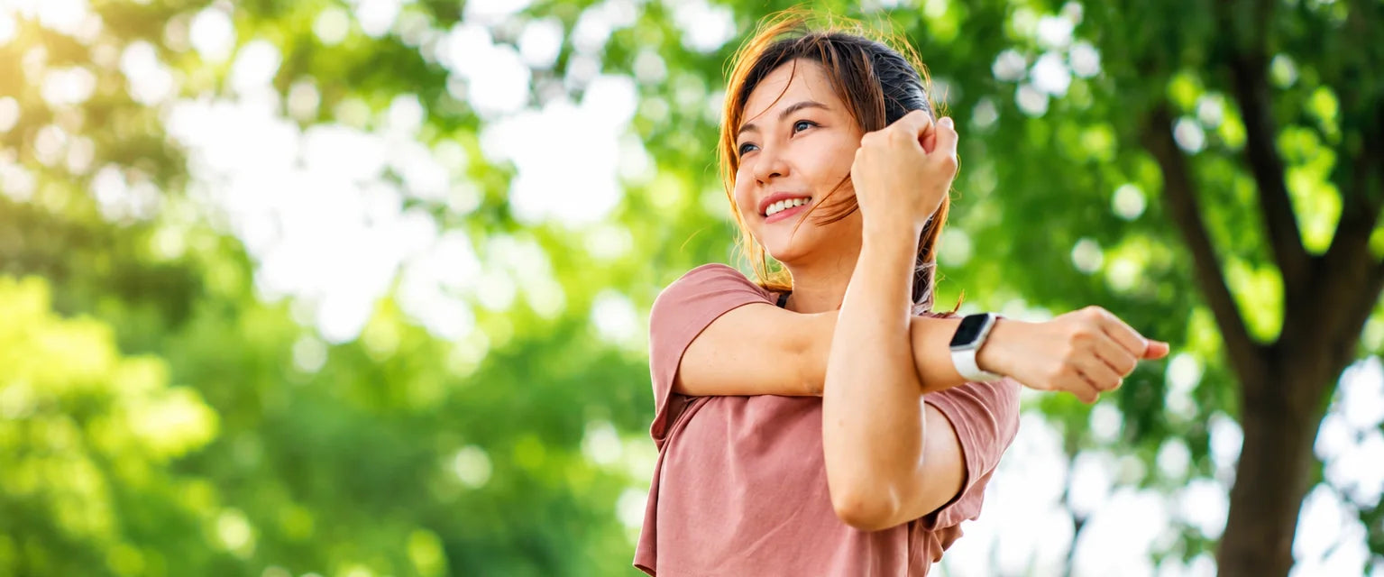 A woman stretching outdoors in a park